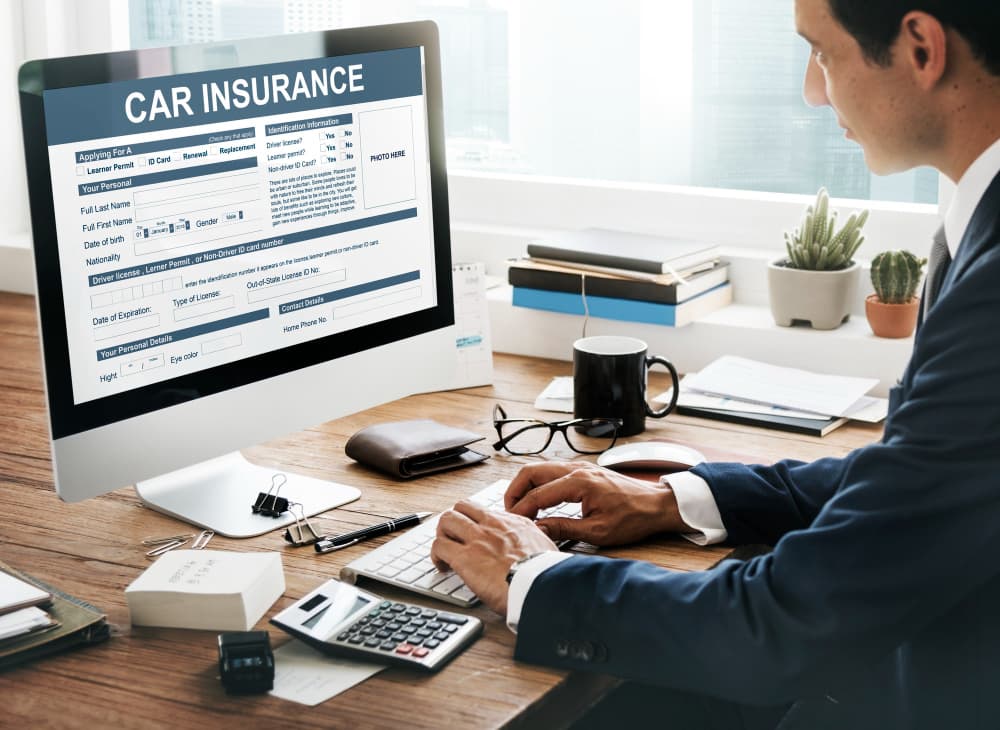 Person completing a car insurance form